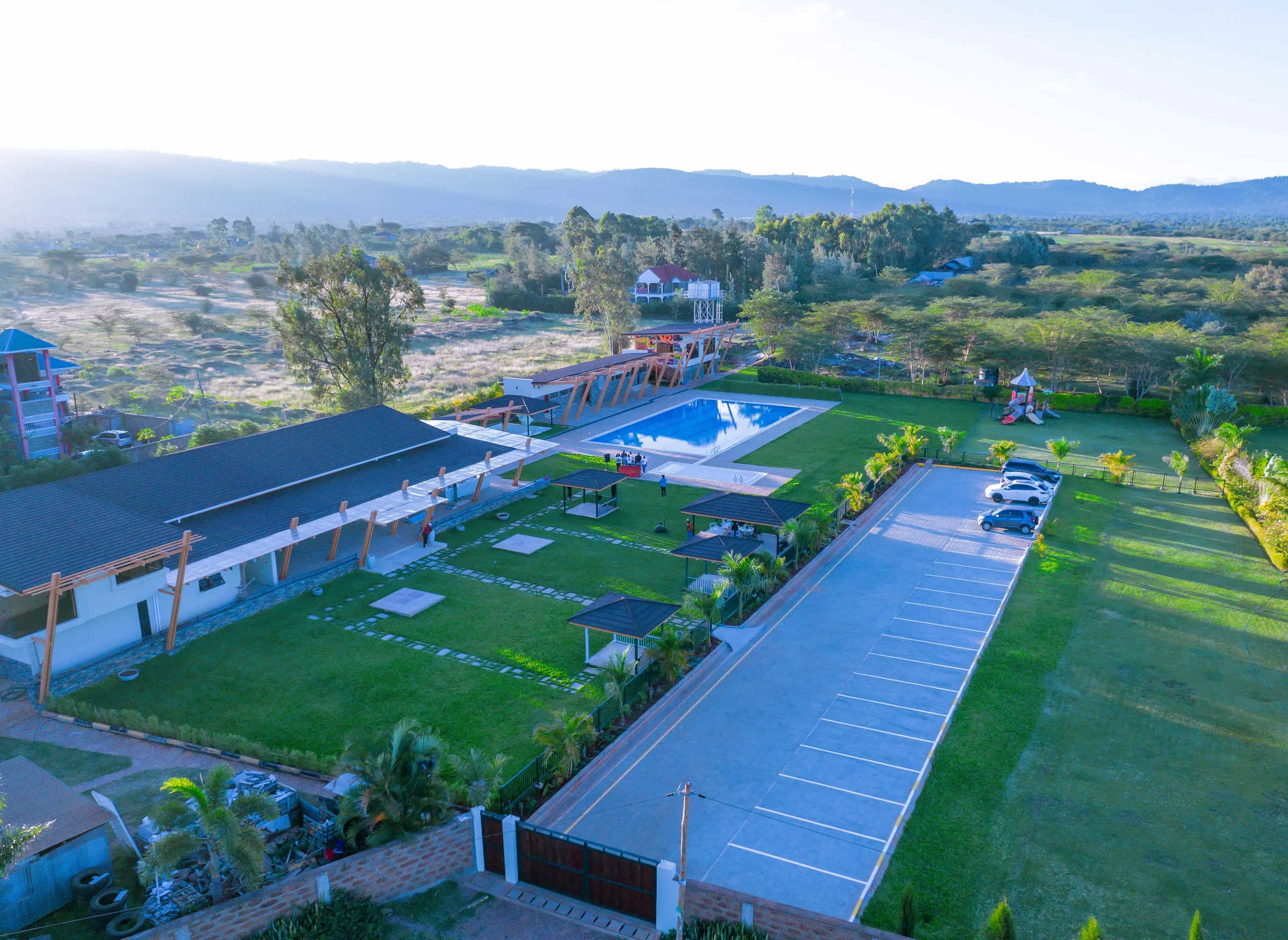 Aerial view of Acacia Woods at golden hour with the escarpment beyond